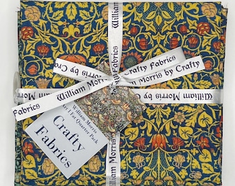 May include: A set of four fat quarter fabric squares featuring a repeating floral pattern in shades of blue, yellow, orange, and green. The fabric is wrapped in a white ribbon with the text "William Morris by Crafty Fabrics" printed on it. The fabric squares are labeled "William Morris Art I Fat Quarter Pack Crafty Fabrics".