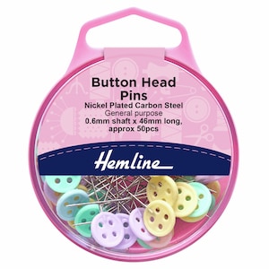 May include: A circular container of button head pins with pastel-colored button-shaped heads. The pins are nickel-plated carbon steel, 46mm long, and come in a pack of approximately 50. The packaging includes the text "Button Head Pins" and "Hemline."