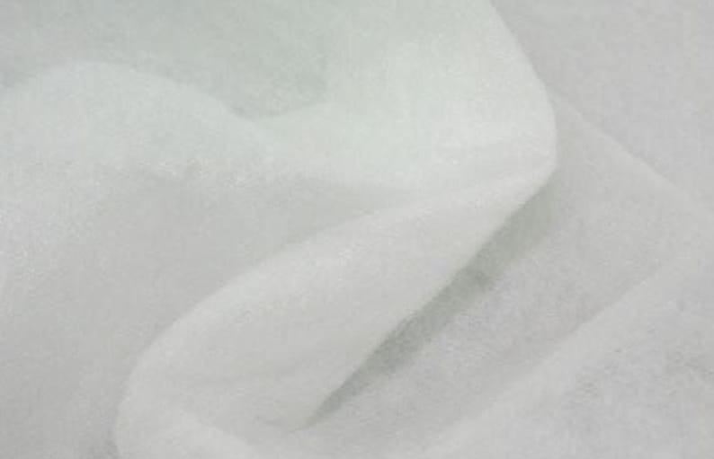 The image is a close-up of a white fabric, possibly a sheer or sheer-like material, with a soft and delicate appearance.