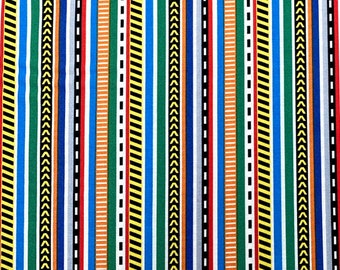 May include: A colorful fabric with vertical stripes in various colors, including yellow, orange, red, blue, green, and black. The stripes have different patterns, including solid, dashed, and chevron.