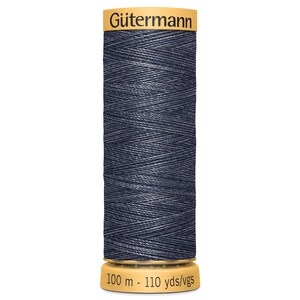 May include: A spool of Gütermann thread in a dark blue colour with a white sheen. The spool is labelled "Gütermann" and "100 m - 110 yds/vgs".