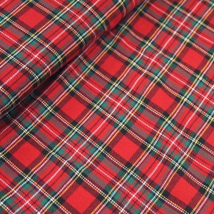 May include: Red, green, white, and black plaid fabric with a woven texture.