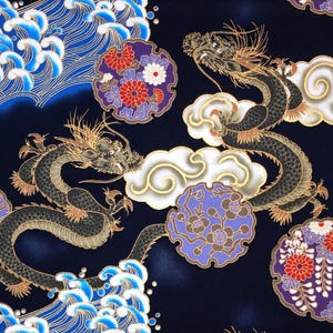 May include: A dark blue fabric with a repeating pattern of gold dragons, stylised clouds, and floral motifs. The dragons are black and gold with a textured appearance. The clouds are white with gold accents. The flowers are red, white, and purple.