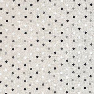 May include: A beige fabric with a repeating pattern of black, white and grey polka dots.