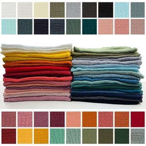 a large number of colorful fabric swatches arranged in a visually appealing manner, showcasing various shades and patterns.