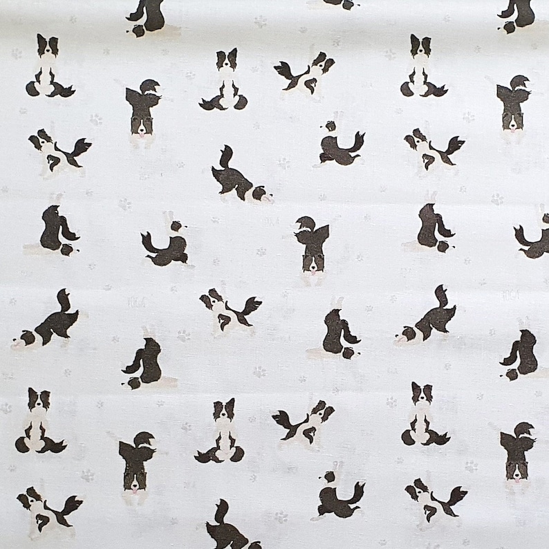 May include: White fabric with a repeating pattern of black and white border collie dogs in various yoga poses.