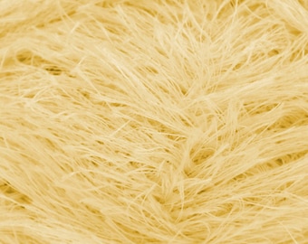 May include: Close-up of a soft, fluffy, pale yellow yarn. The yarn is made of fine, delicate fibers that create a fuzzy, textured appearance.