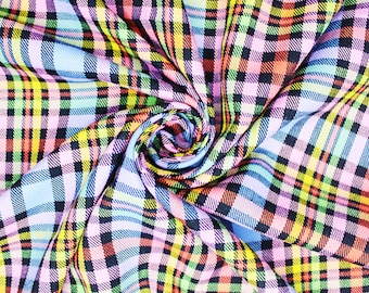 May include: A colorful plaid fabric with a swirling pattern. The fabric is made of a soft, woven material and features a variety of colors, including pink, blue, yellow, green, and red.