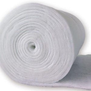 A large, white, cylindrical object, possibly a piece of insulation or a rolled-up fabric, is shown in the image.