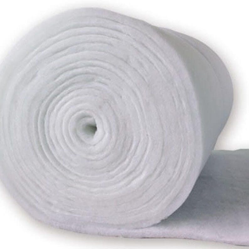 A large, white, cylindrical object, possibly a piece of insulation or a rolled-up fabric, is shown in the image.