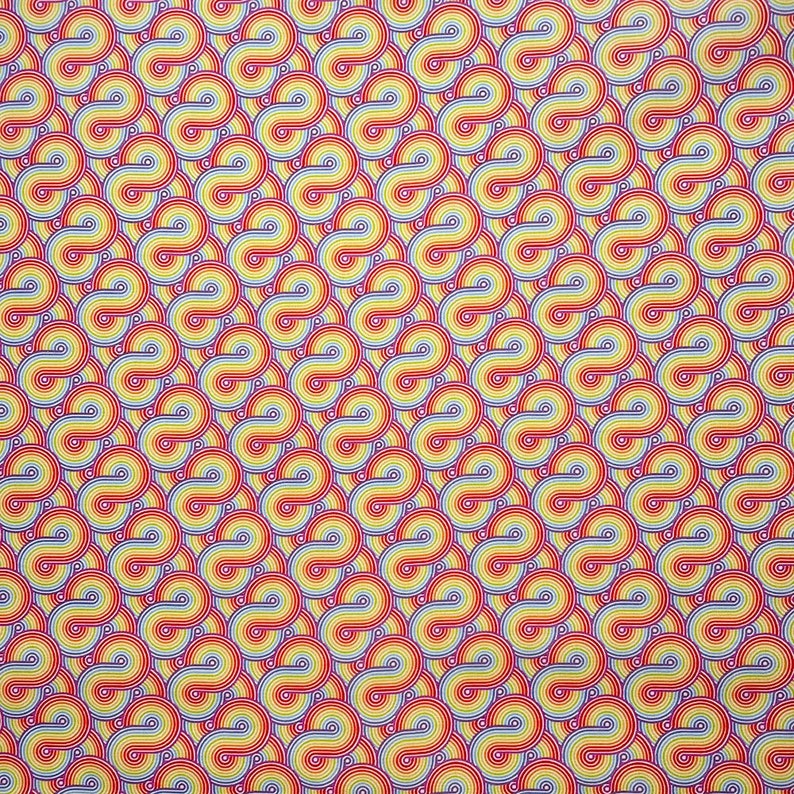 May include: A repeating pattern of colorful, overlapping circles. The circles are made up of thin, concentric lines in shades of red, orange, yellow, blue, and white. The background is a light yellow.