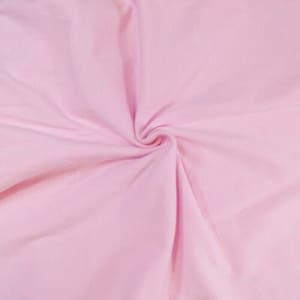 May include: A close-up of a soft, pink fabric with a smooth texture. The fabric is folded and draped, creating a gentle curve.
