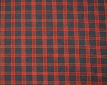 May include: Red and black plaid fabric with a woven texture.