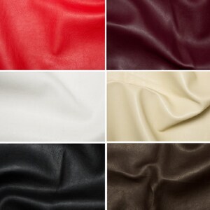 May include: Four fabric swatches in different colors: red, white, beige, and brown. The fabric has a leather-like texture.