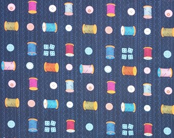 May include: A dark blue fabric with a repeating pattern of colorful spools of thread, buttons, and dice. The spools of thread are in various colors, including red, pink, orange, yellow, green, blue, and purple.