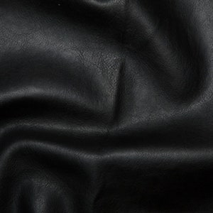 May include: Black faux leather fabric with a textured surface. The fabric is wrinkled and folded.