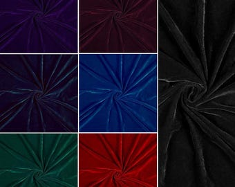 May include: A collection of velvet fabric swatches in various colors. The swatches include deep purple, burgundy, navy blue, royal blue, emerald green, and red. A black velvet swatch is also included. The fabric is soft and has a slight sheen.