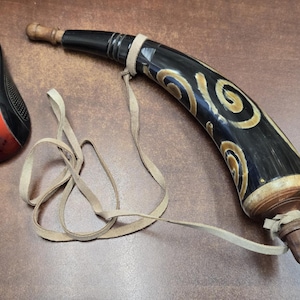 May include: A white ceramic mug with a black handle and the text "But First, Coffee" in a black, bold font. The mug is on a white surface. The mug is 4 inches tall.