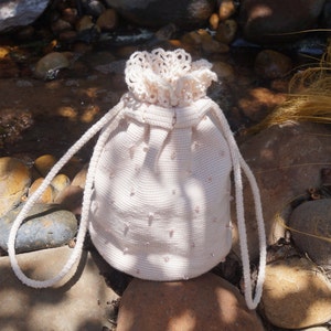 Lace Crochet Bag Pattern for drawstring bag made with Koigu merino wool yarn.  Requires intermediate skill level.  Uses 4 skeins of yarn.