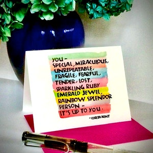 May include: A colorful card with a rainbow background and the text "you - SPECIAL, MIRACULOUS, UNREPEATABLE, FRAGILE, FEARFUL, TENDER, LOST, SPARKLING RUBY EMERALD JEWEL, RAINBOW SPLENDOR PERSON - IT'S UP TO YOU. -CORITA KENT"