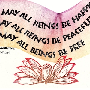 May include: A print with the words "May all beings be happy, peaceful, free" in black, arched text. Below the text is a lotus flower illustration in red and brown. The words "Lovingkindness Meditation" are below the text.