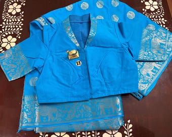 May include: A bright blue blouse with a V-neck and short sleeves, paired with a blue and silver patterned fabric with an elephant design.