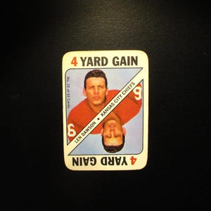 May include: A vintage football card featuring Len Dawson, quarterback for the Kansas City Chiefs. The card is red and white with the text "4 Yard Gain" and "No. 25 of 52 Cards".