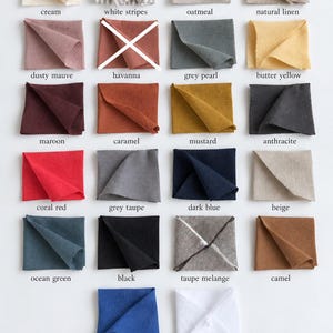 May include: A grid of twenty-one fabric swatches in various colors including cream, white stripes, oatmeal, natural linen, dusty mauve, grey pearl, butter yellow, maroon, caramel, mustard, anthracite, coral red, grey taupe, dark blue, beige, ocean green, black, taupe melange, camel, royal blue, and white. One swatch is marked with a white X.