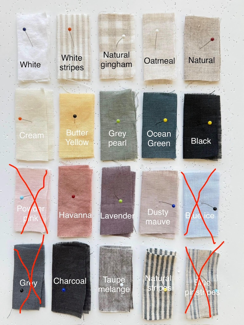 May include: A collection of fabric swatches in various colors and patterns, including white, cream, and black. The swatches are labeled with color names like "Butter Yellow" and "Ocean Green". Each swatch is pinned with a colored pin.