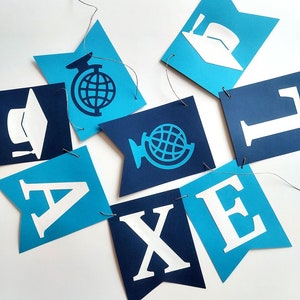 Blue and navy blue graduation banner with white graduation cap and a globe symbol.