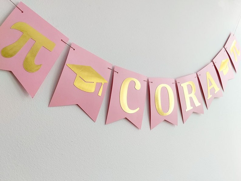 Coquette graduation banner pink and gold.