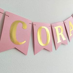 Graduation decorations. Pink and gold graduation banner.