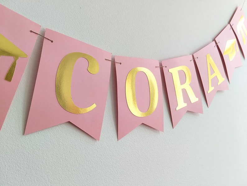 Graduation decorations. Pink and gold graduation banner.