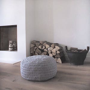 Light grey crochet round ottoman.