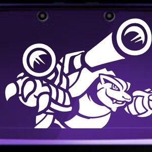 May include: White vinyl sticker of a cartoon monster with two cannons on its back. The monster is facing right and has a toothy grin. The sticker is on a purple Nintendo 3DS.
