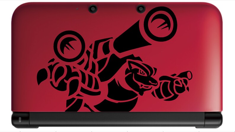 May include: A red Nintendo 3DS handheld gaming console with a black and white sticker of a Pokemon character on the top cover. The character is a large, muscular, humanoid creature with a large head and a long, pointed snout. The character is holding a large, cylindrical weapon in its right hand.