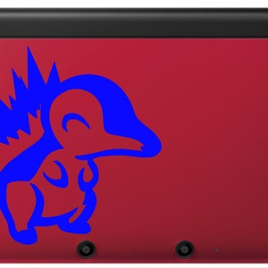May include: A red Nintendo 3DS handheld gaming console with a blue Pikachu character sticker on the top cover.
