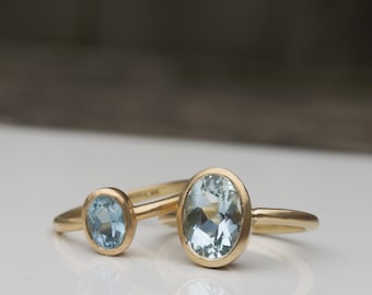 Aquamarine ring oval large and small in recycled 18ct yellow gold