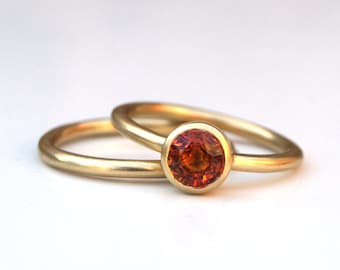 Orange sapphire ring set in 18ct recycled yellow gold
