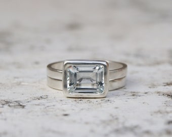 Emerald cut white topaz ring set in recycled silver