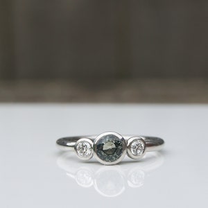Green sapphire and diamond three stone ring
