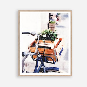 May include: A watercolor painting of a blue bicycle with a wooden crate filled with flowers. The bicycle is parked on a street with a white building in the background.