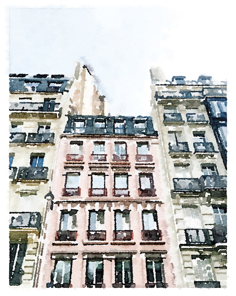 Puede incluir: Una pintura de acuarela de un edificio parisino con una fachada rosa y ventanas negras. El edificio est&aacute; rodeado de otros edificios con fachadas blancas y ventanas negras.