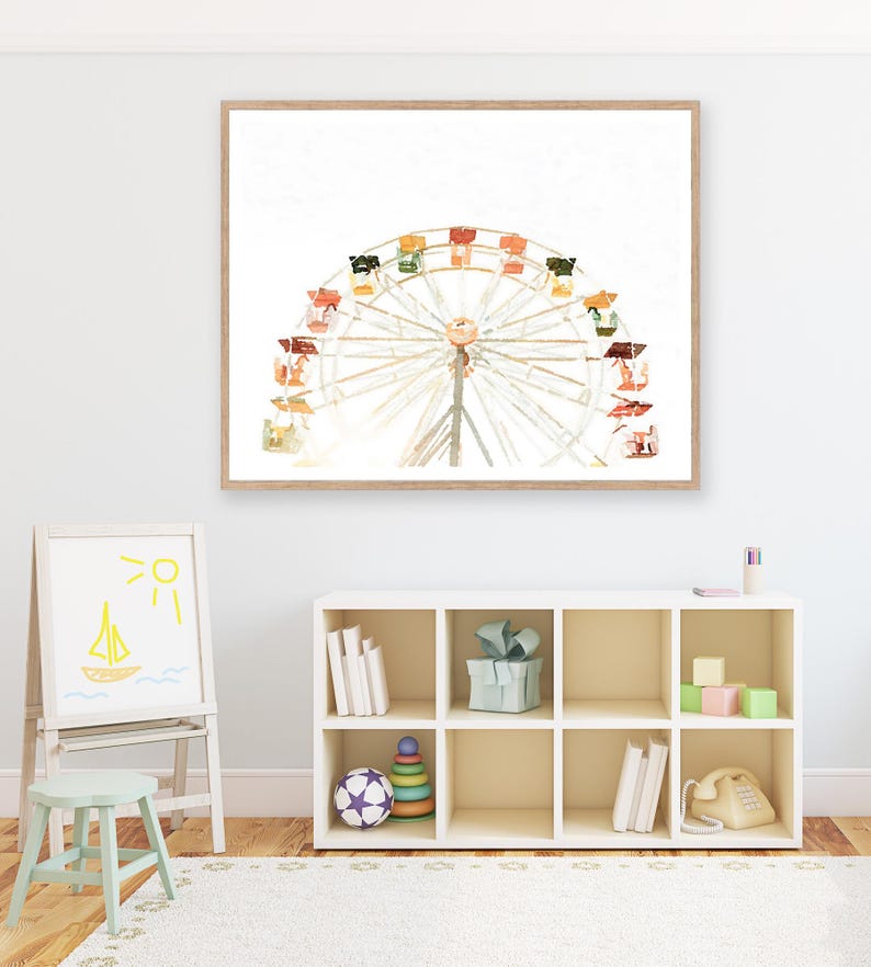 May include: A watercolor painting of a Ferris wheel with colorful gondolas against a white background. The painting is framed in a light wood frame.