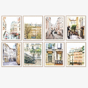 France Paris Provence Avignon Neutral Watercolor Gallery Wall Art Prints Set of 8 Digital Printable Buildings Street French Decor 8x10 11x14. A set of six watercolor paintings depicting Parisian street scenes. The paintings feature buildings with balconies, windows, and doors. Some of the paintings include streetlights, trees, and people walking on the street. The paintings are in a muted color palette of beige, brown, and gray.