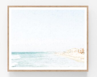 May include: A watercolour painting depicting a beach scene with a pale blue sky, turquoise ocean waves, and a sandy shore with buildings in the distance.