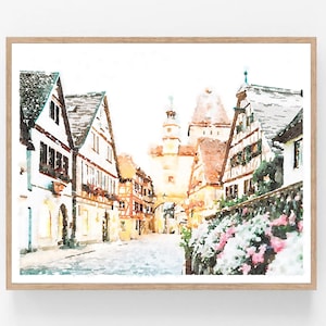 May include: A watercolour painting of a European village street with colourful buildings and a tall tower in the background. The street is lined with flowers and greenery.