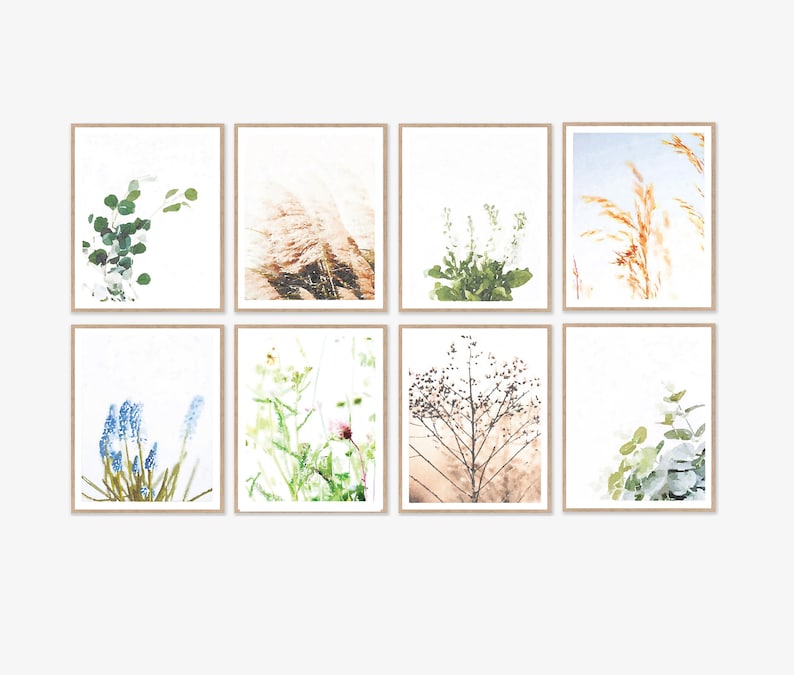 May include: Set of eight botanical prints featuring various plants and flowers in muted tones. The prints are framed in a simple, light wood frame.