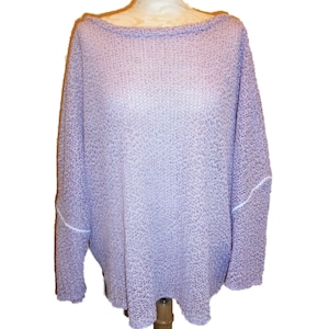 May include: A light purple long-sleeve sweater with a loose, open-knit texture and a wide boat neckline. The garment features a relaxed fit with dropped shoulders and visible white stitching along the seams of the sleeves and the body.