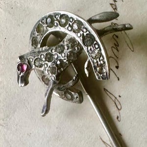 Genuine antique equestrian horse and horseshoe dimensional stickpin adorned with costume paste rhinestones and cabochon ruby eye